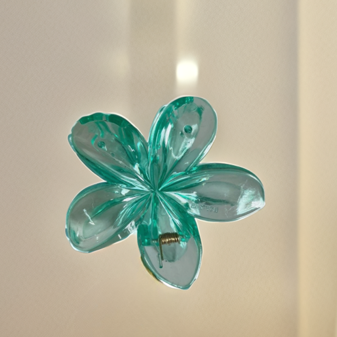 Turquoise flower-shaped object on a beige background
