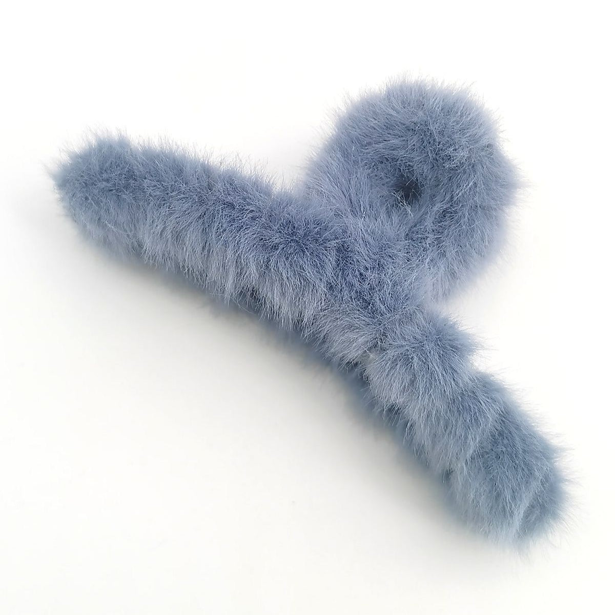 Blue fluffy hair clip on a white background