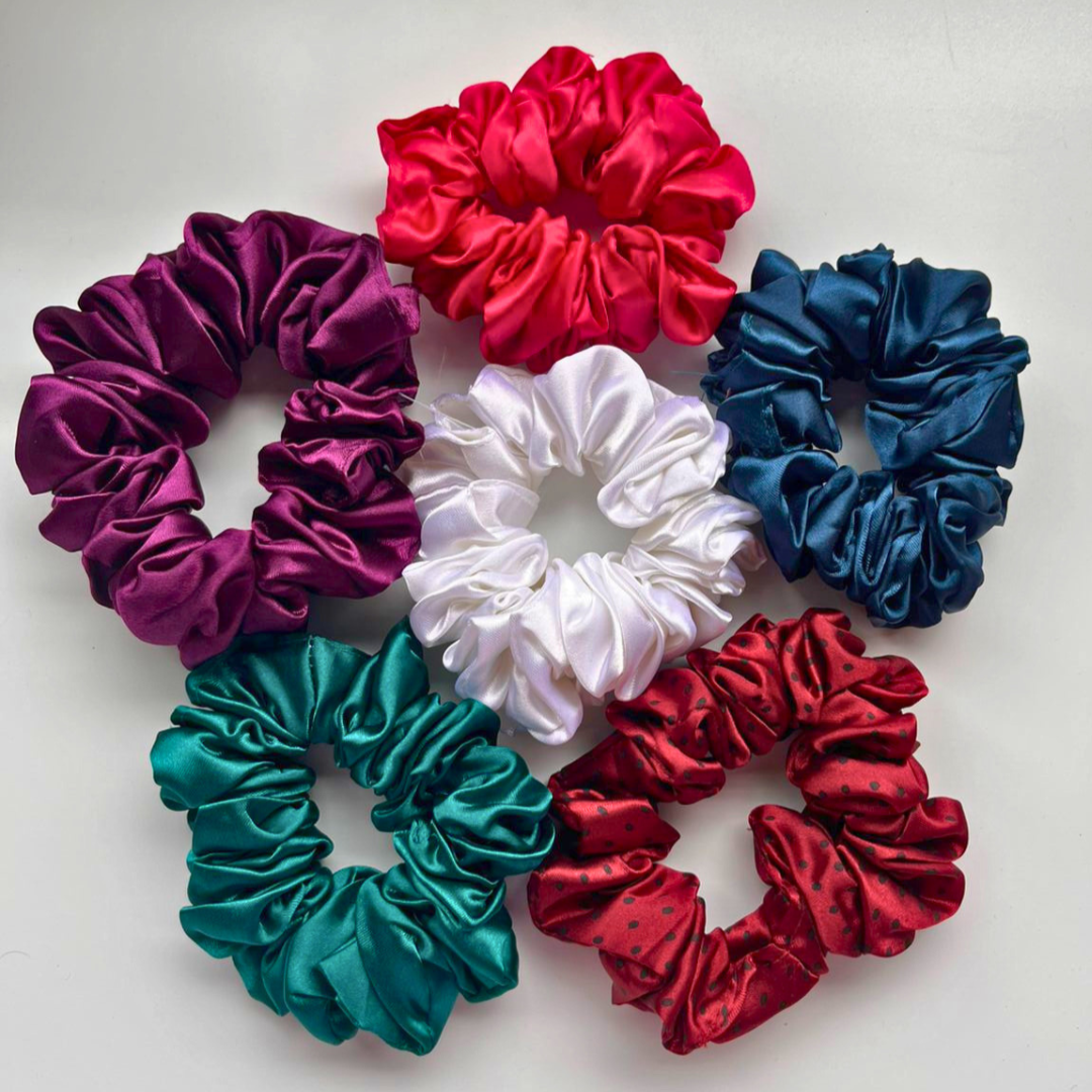 Set of colorful satin scrunchies on a white background
