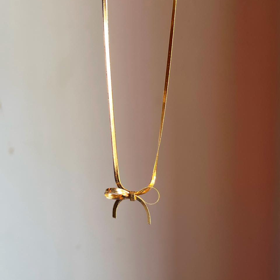 Gold necklace on a plain background