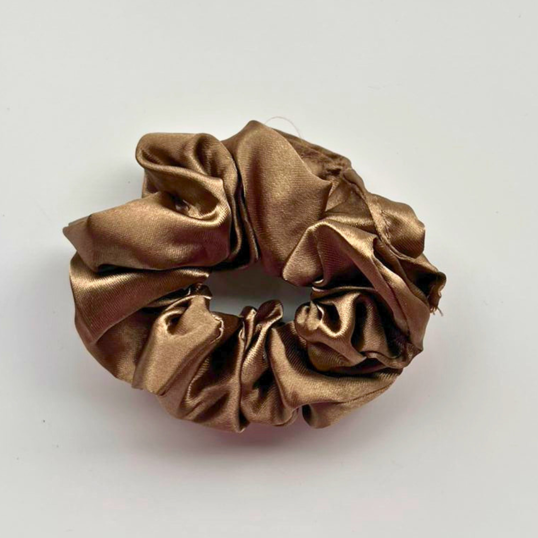 Bronze scrunchie on a light gray background