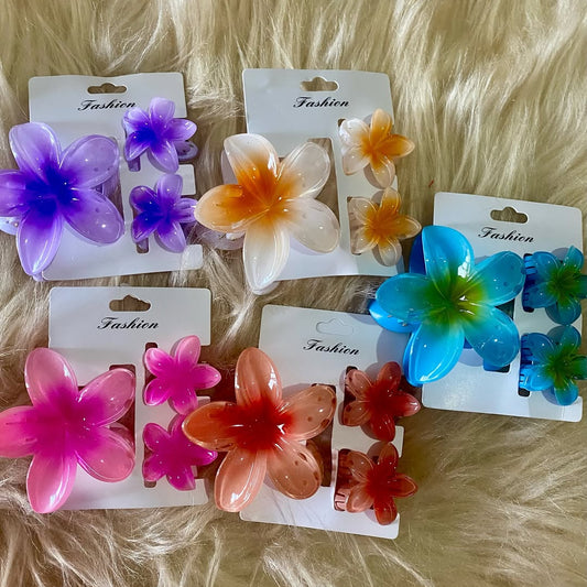 Set of colorful flower-shaped hair clips on cards with 'Fashion' branding, displayed on a fur surface.