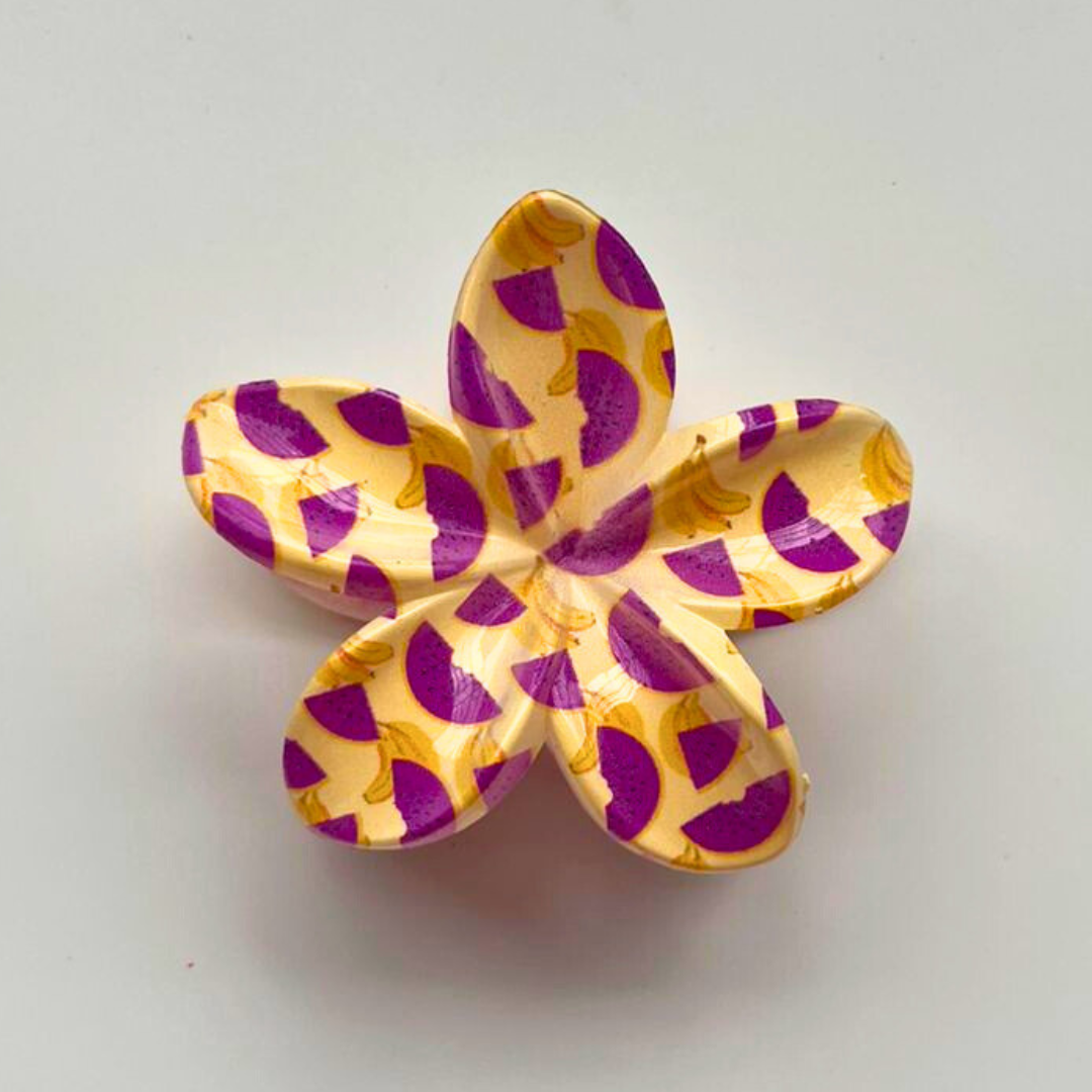 Flower-shaped object with purple and yellow pattern on a white background