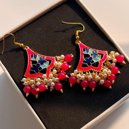 Decorative earrings in a box on a light background