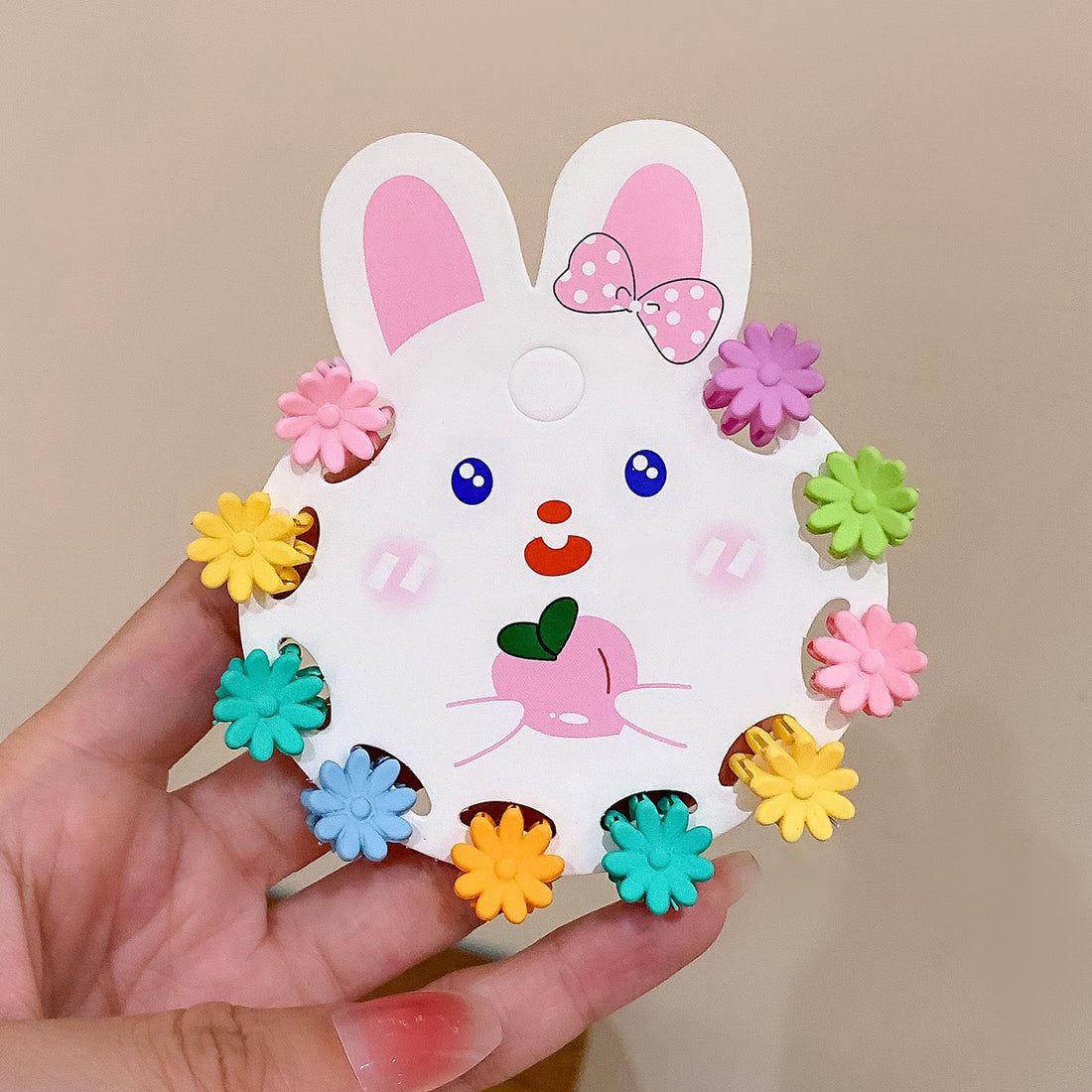 Colourful children's hair pins set with a bunny design on a beige background