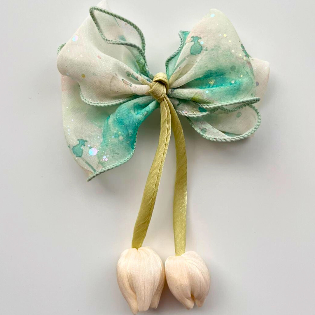 Decorative bow with green and white colors on a light gray background