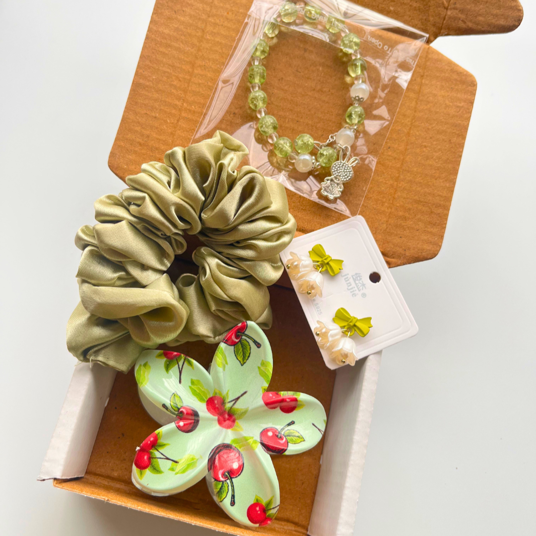 Set of green scrunchie, Cute bracelet, Floral Claw Clip and earrings in a box on a white background. Perfect for gifting your loved ones.