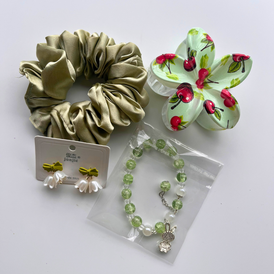 Set of green scrunchie, bracelet, earrings, and cherry-themed claw clip on a white background. Ideal for gifting and hampers under budget.
