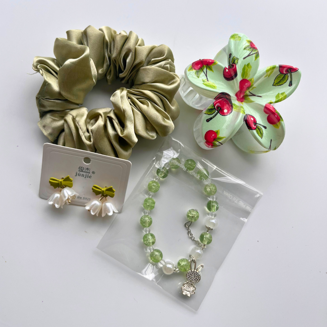 Set of green scrunchie, bracelet, earrings, and cherry-themed claw clip on a white background. Ideal for gifting and hampers under budget.