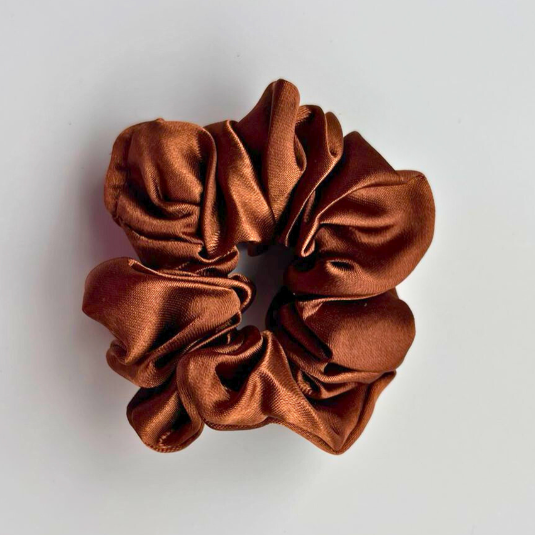 Brown scrunchie on a light gray background