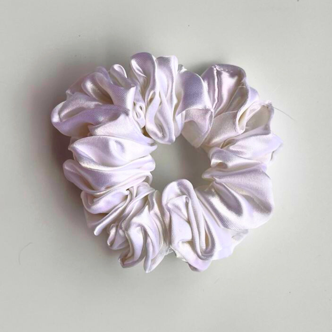White satin scrunchie on a light gray background