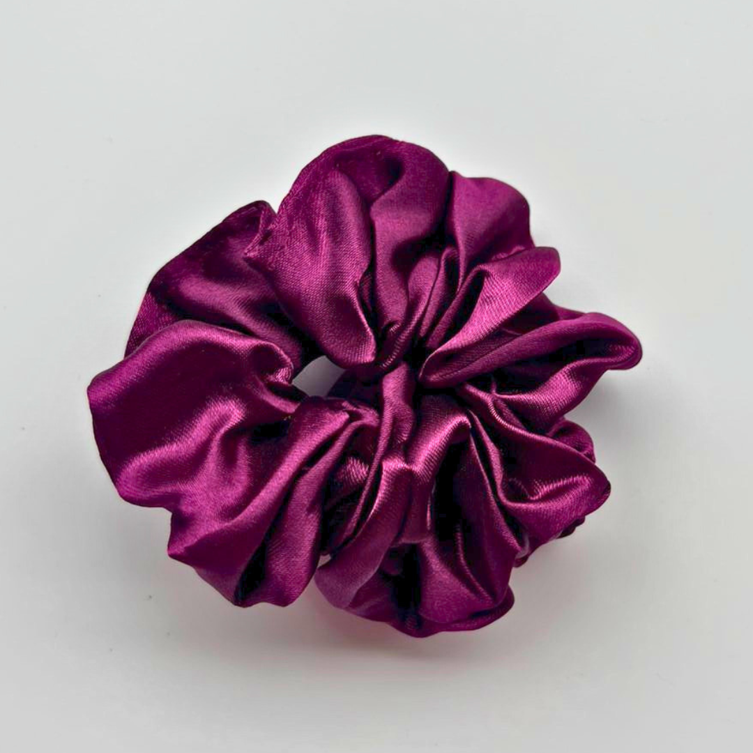 Purple satin scrunchie on a white background