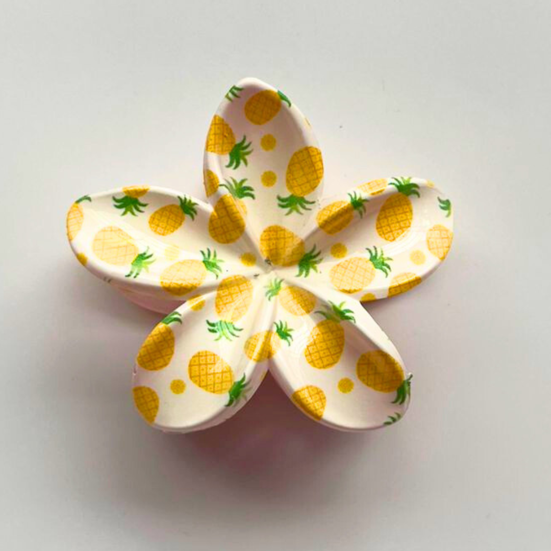 Flower-shaped object with pineapple pattern on a light gray background