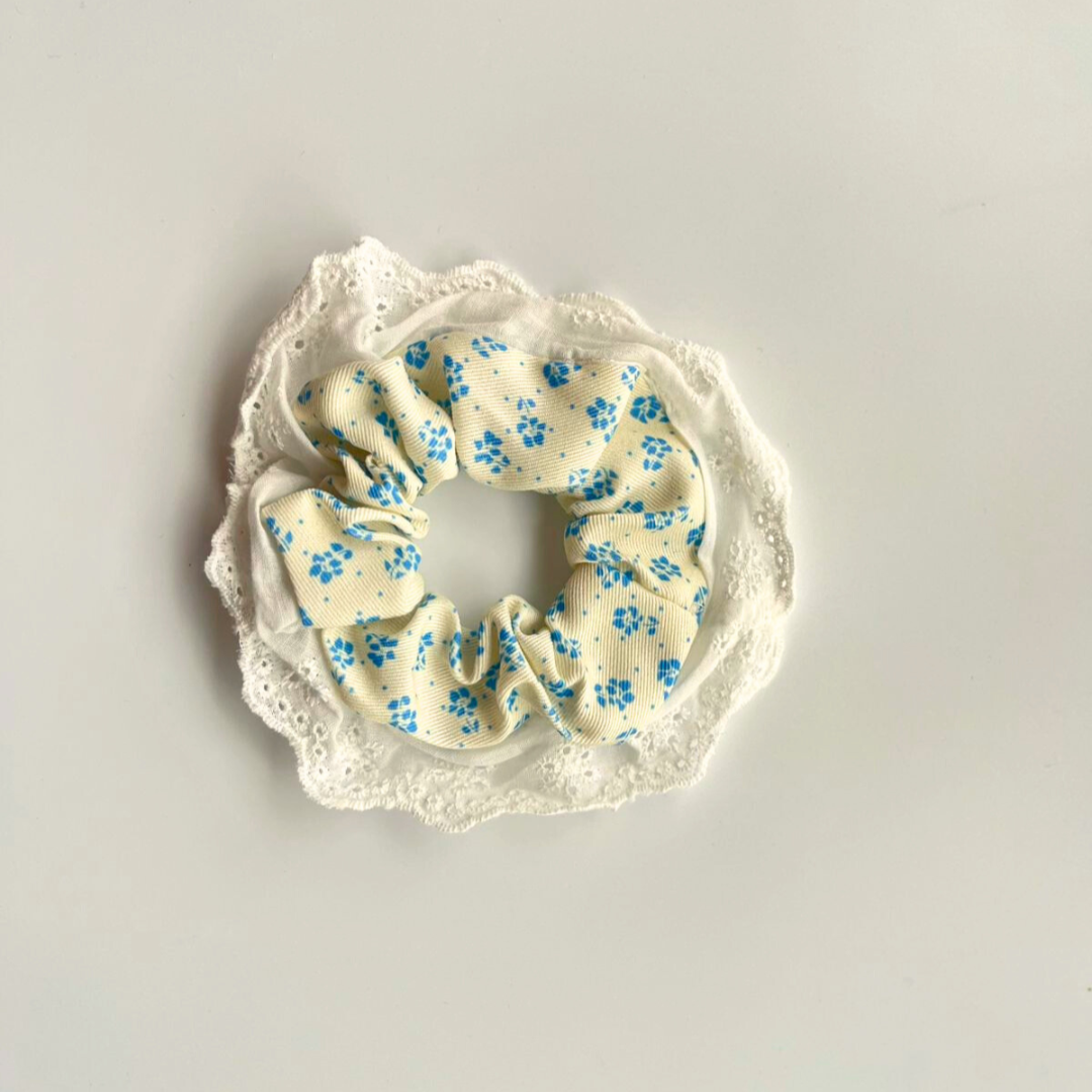Floral scrunchie with lace trim on a light gray background