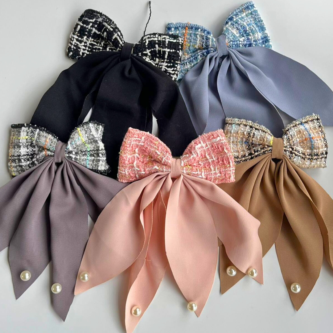 Set of colorful bow-tie accessories on a light gray background