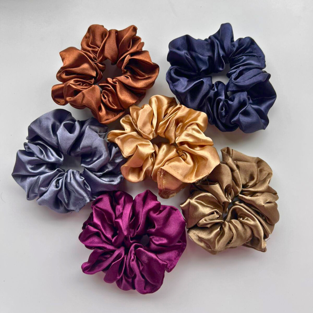 Set of colorful satin scrunchies on a white background
