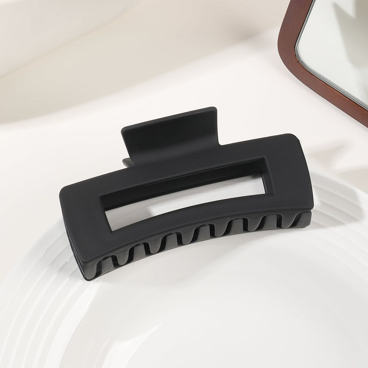 Black hair clip on a white surface