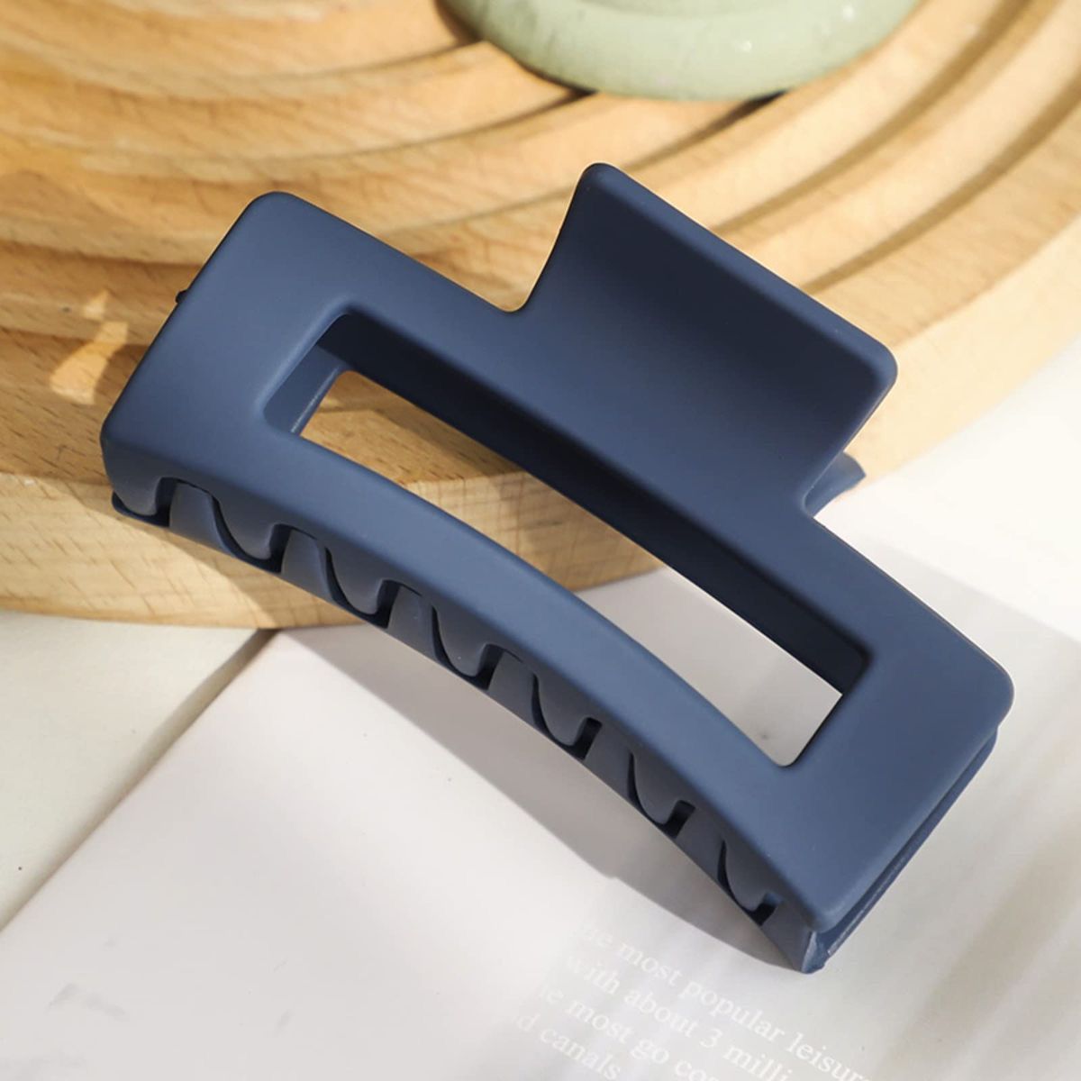 Blue hair clip on a wooden surface