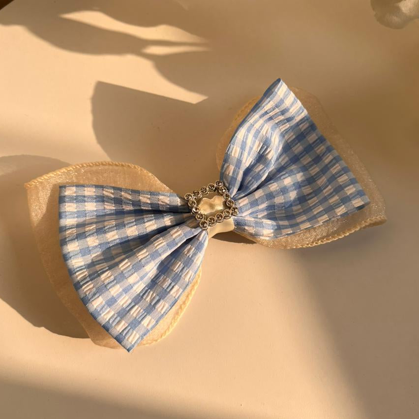 Blue and white checkered bow on a beige background
