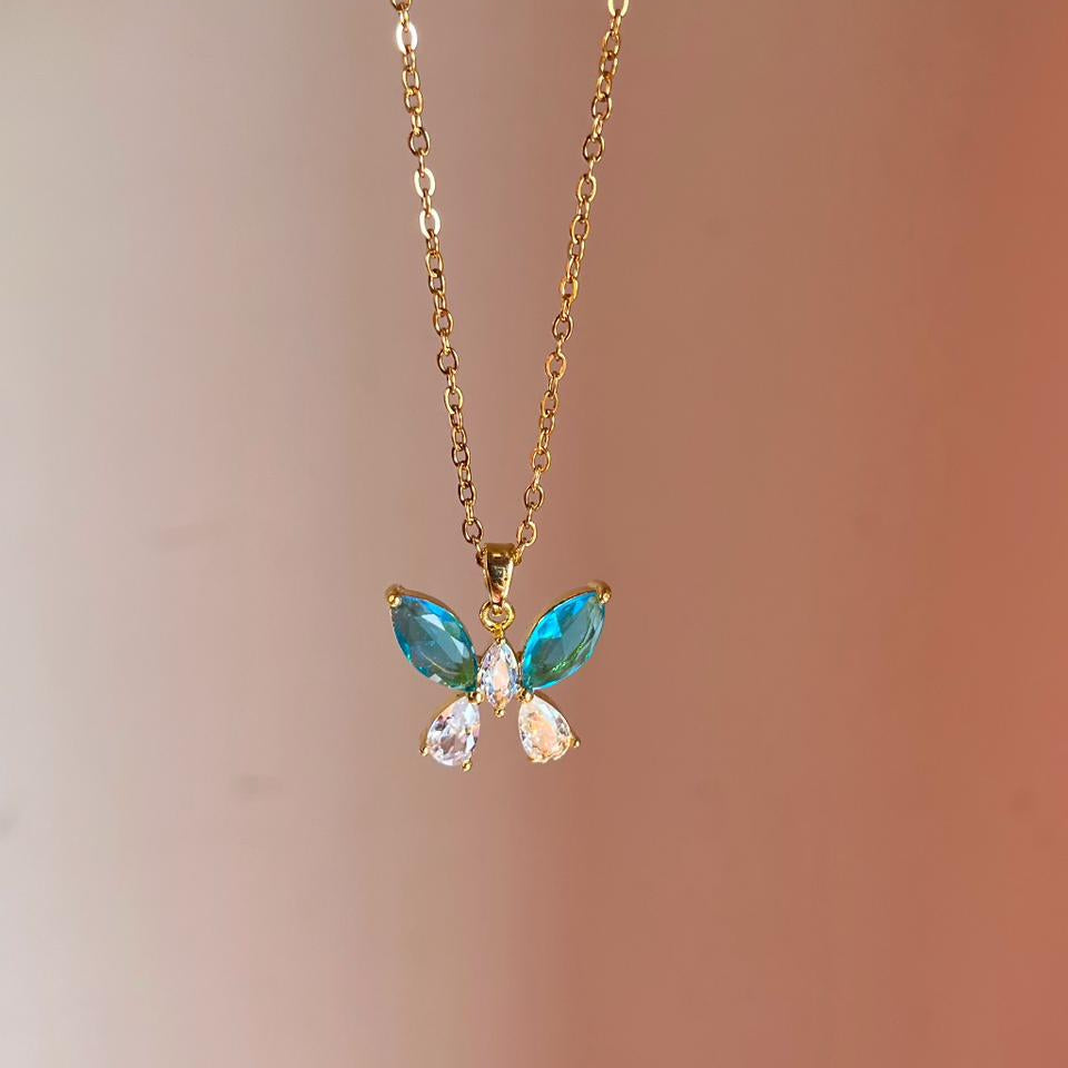 Butterfly-shaped necklace with gemstones on a blurred background