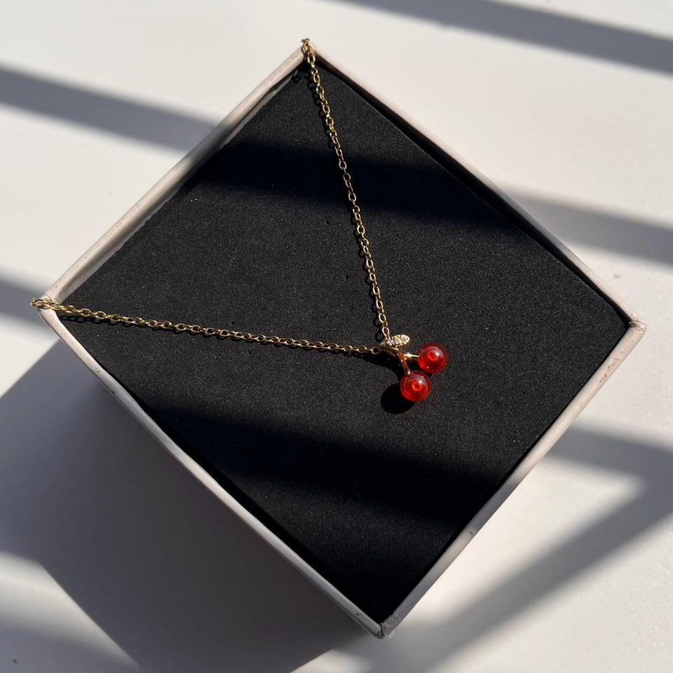 Necklace with red beads on a black box