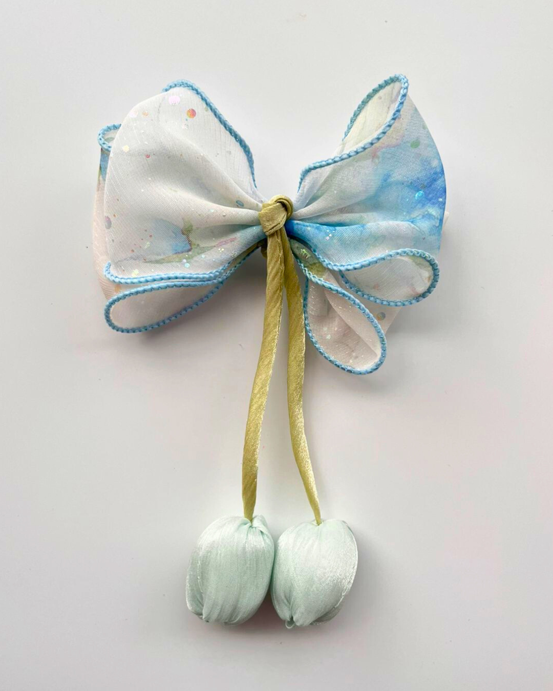 Decorative bow with blue and white pattern on a light gray background