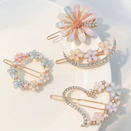Set of decorative hair clips with floral and pearl designs on a light background