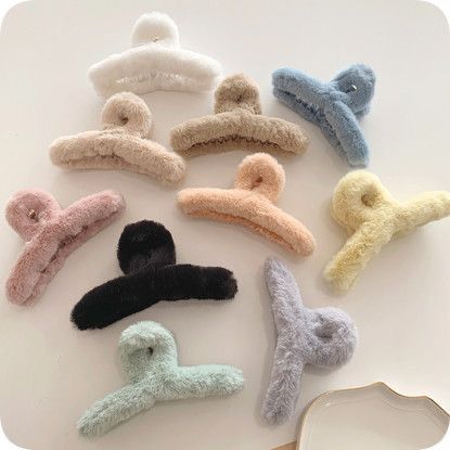 Collection of colorful hair clips on a light background