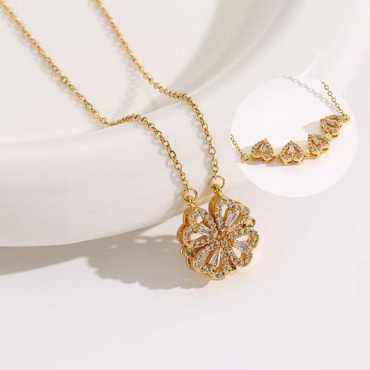 Gold necklace with a floral pendant on a white background