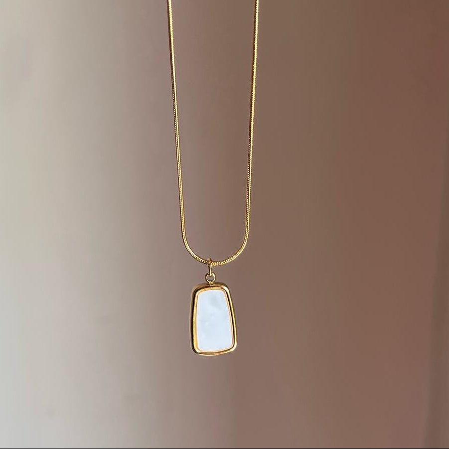 Necklace with a pendant on a plain background