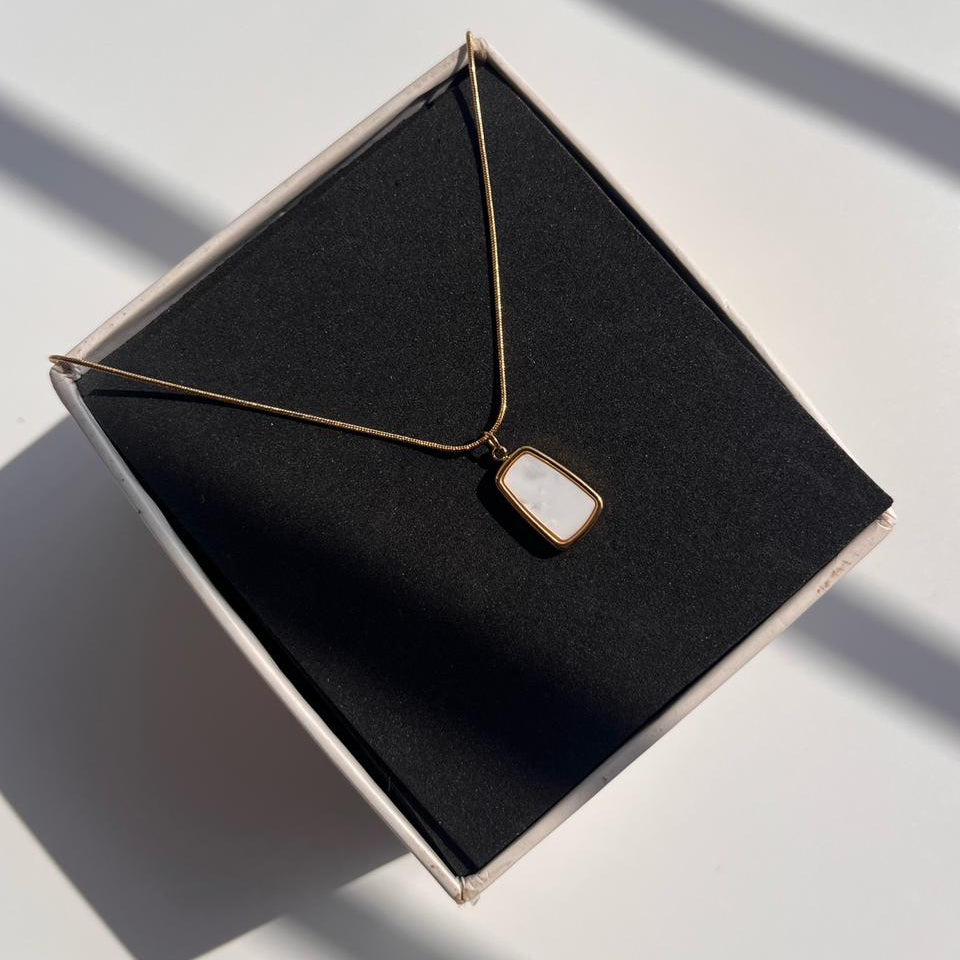 Necklace with a pendant on a black jewelry box