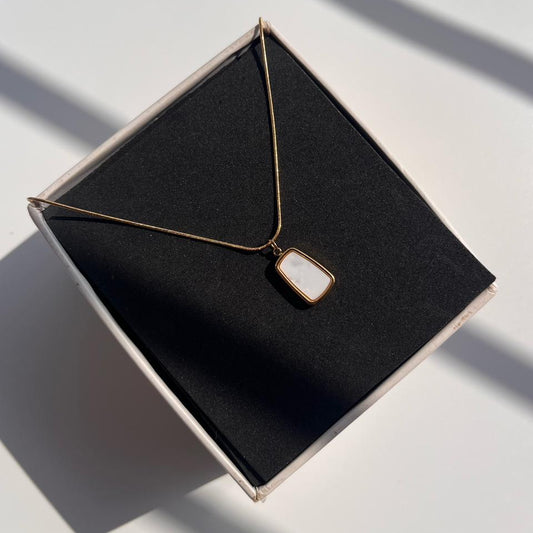 Necklace with a pendant on a black jewelry box