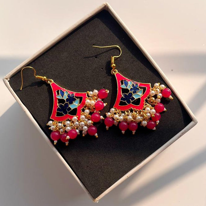 Decorative earrings in a box on a light background