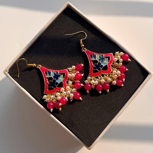Decorative earrings in a box on a light background