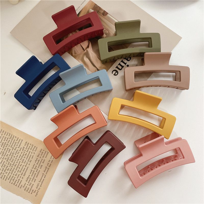 Colorful hair clips on a textured surface