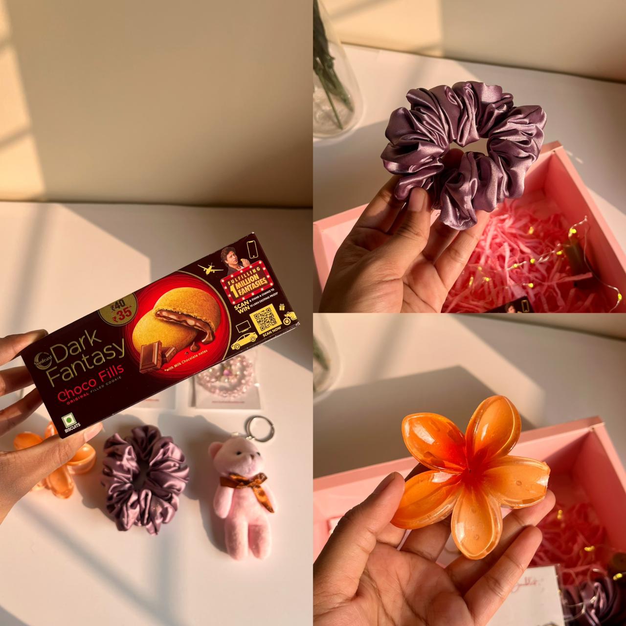 Collage of a box of Dark Fantasy chocolate, a purple scrunchie, and an orange hair clip.