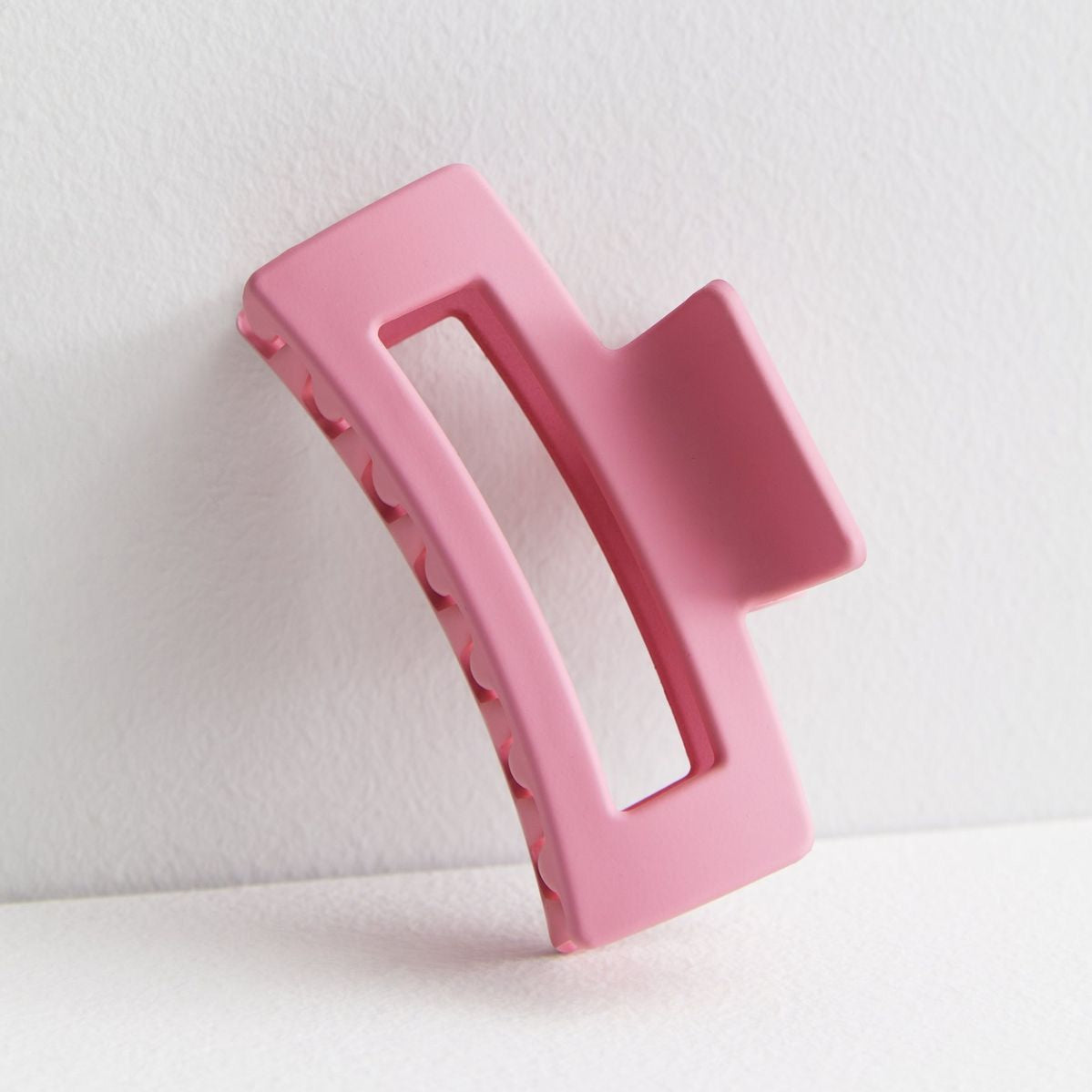 Pink hair clip on a white background
