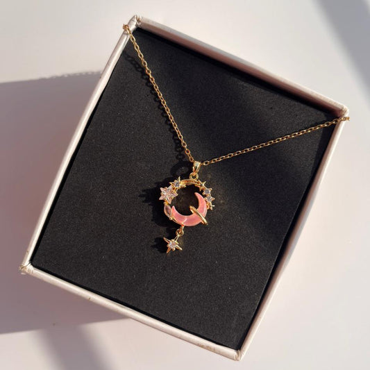 Necklace with a moon and star pendant in a box on a white surface