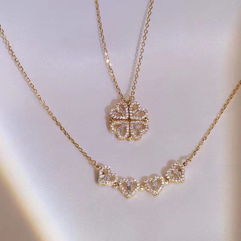 Gold necklace with diamond accents on a light gray background