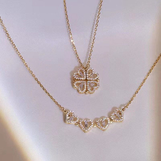 Gold necklace with diamond accents on a light gray background