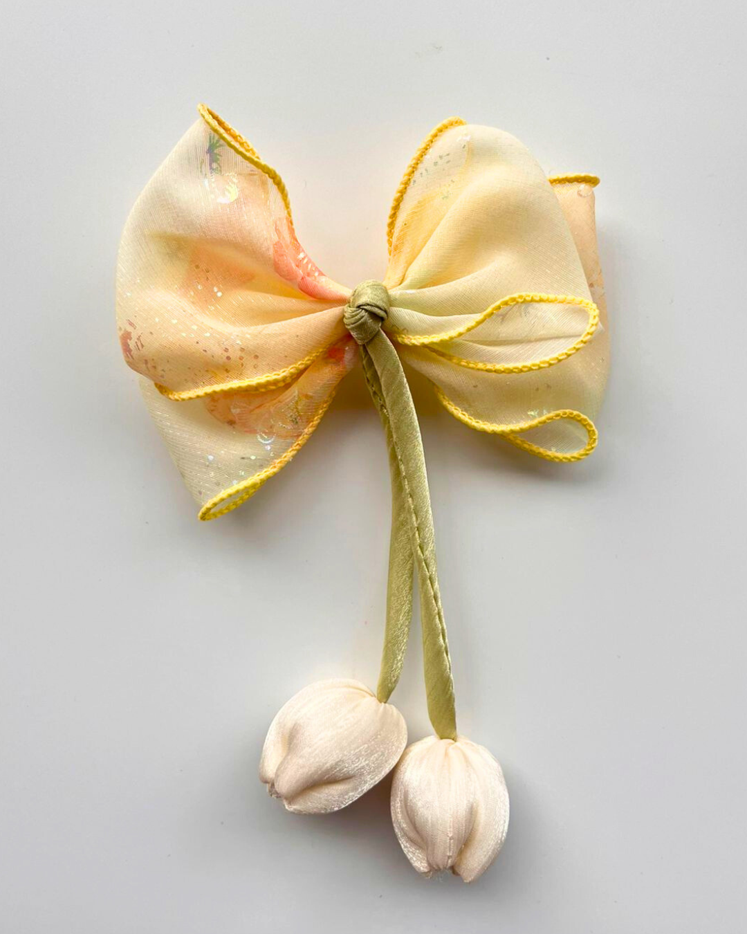 Decorative bow with flowers on a light gray background