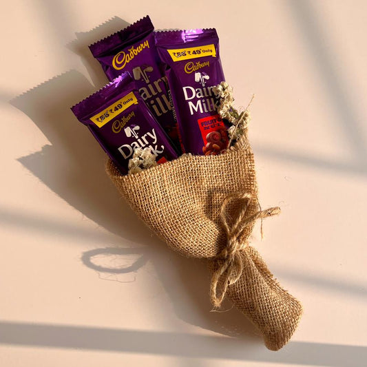Bouquet of Cadbury Dairy Milk chocolate bars wrapped in jute bouquet on a light background