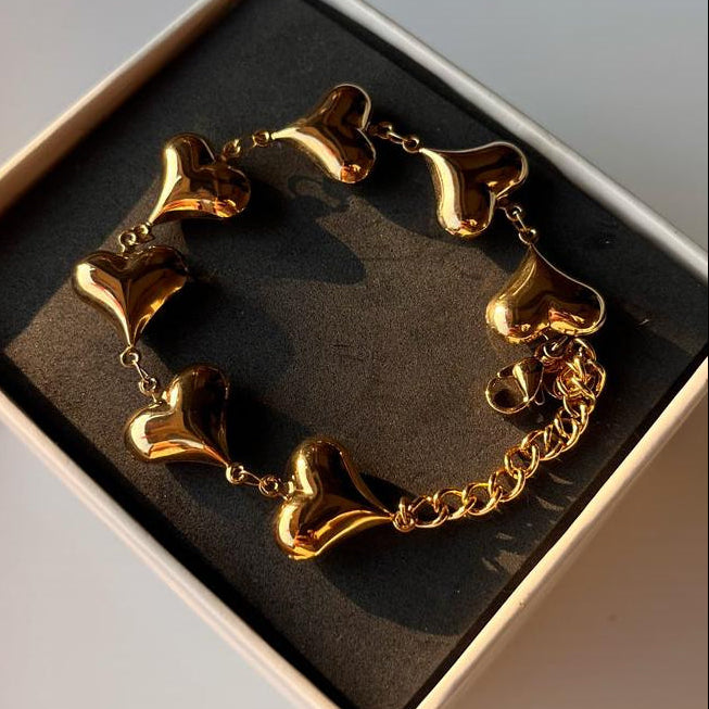 Gold bracelet in a box on a light background