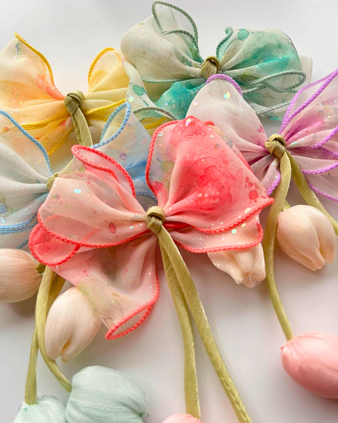 Colorful fabric bows on a white background