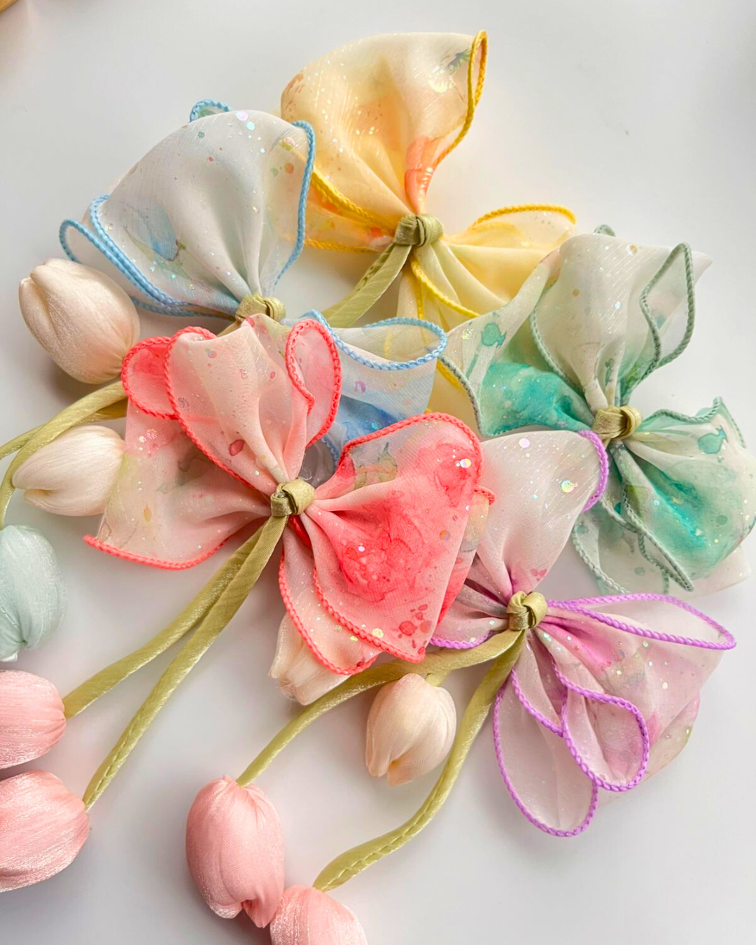 Colorful fabric flowers on a white background